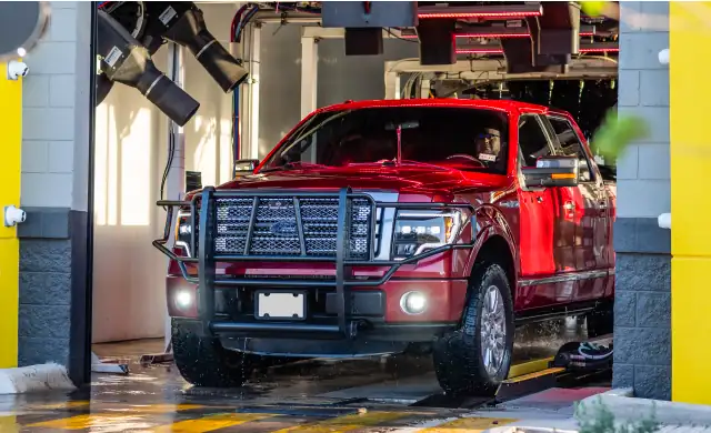 Red car in a car wash